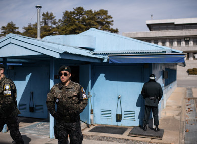 South Korean soldiers stand guard before the military demarcation line and North Korea's Panmun Hall, in the truce village of Panmunjom.