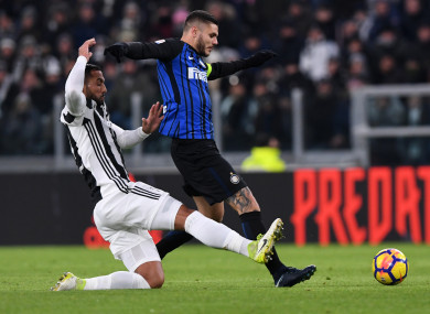 Inter Milan captain Mauro Icardi is tackled by Juventus defender Medhi Benatia.