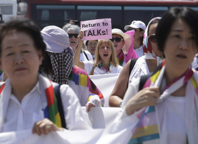 Activists march toward the Unification Bridge, which leads to Panmunjom in the Demilitarised Zone, South Korea,