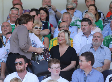 DUP Leader Arlene Foster walks past Sinn Fein Vice President Michelle O'Neill at the Ulster final.