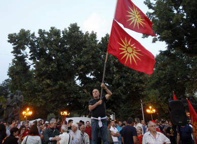 A man waves the former national flags during a protest in Skopje, Macedonia.