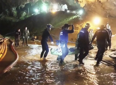Rescuers hold a rescued boy inside the Tham Luang Nang Non cave in Mae Sai, Chiang Rai province, in northern Thailand.