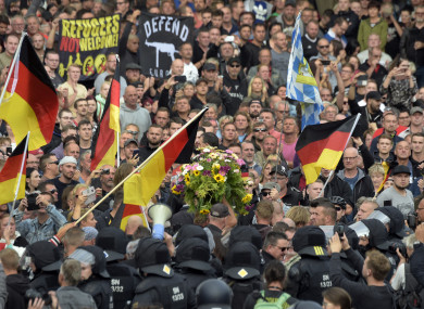 Protesters carry a wreath as they gather for a far-right protest in Chemnitz, Germany
