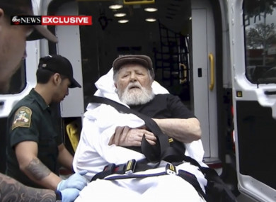 Jakiw Palij, a former Nazi concentration camp guard, is carried on a stretcher from his home into a waiting ambulance in the Queen, New York.