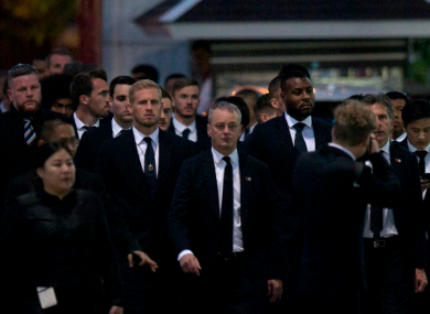Players and officials from Leicester City arrive at a Buddhist temple to participate in the funeral rituals of Vichai Srivaddhanaprabha in Bangkok, Thailand.
