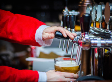 File photo of a man dressed as Santa Claus pulling a pint.