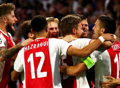 Ajax players celebrate a goal.