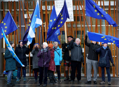 Pro-European protestors outside the Scottish Parliament, Edinburgh, as a vote is held against Theresa May's proposed Brexit deal.