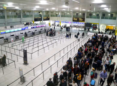 Passengers queue for flights at Gatwick Airport as the airport and airlines work to clear the backlog of flights.