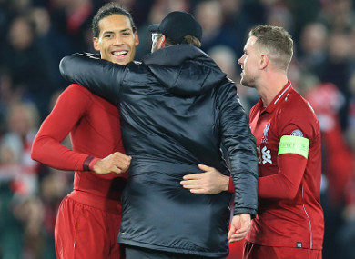 The defender celebrates with Jurgen Klopp and Jordan Henderson last night.