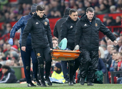 Holding is stretchered off at Old Trafford.