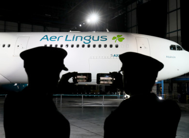 Pilots take photos of an Aer Lingus A330 displaying the new branding during the official unveiling at Dublin Airport.