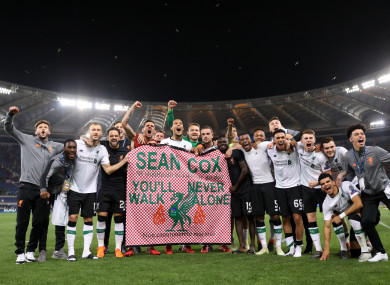 Liverpool players hold aloft a banner in tribute of supporter Sean Cox who remains in serious condition following an assault prior to a Champions League game last year.