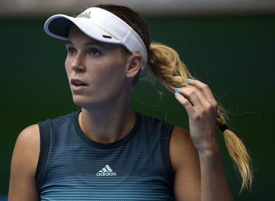 Denmark's Caroline Wozniacki prepares to serve to Sweden's Johanna Larsson during their second round match.