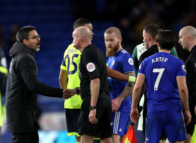 David Wagner (left) and match referee Lee Mason shake hands after the final whistle