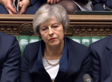 Prime Minister Theresa May listens to Labour leader Jeremy Corbyn speaking after losing a vote on her Brexit deal in the House of Commons, London.