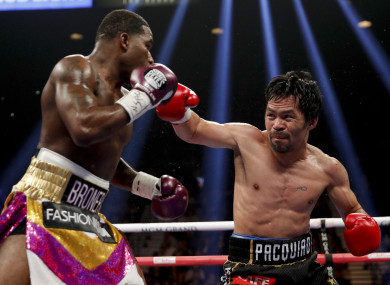 Manny Pacquiao throws a right to Adrien Broner in the WBA welterweight title boxing match in Las Vegas.