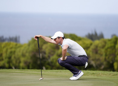 Rory McIlroy lines up a putt on the 14th hole yesterday.