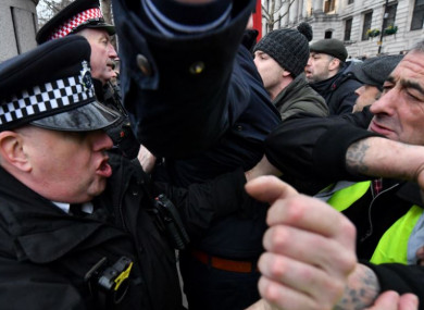Police officers scuffle with pro-Brexit demonstrators at Trafalgar Square, London, yesterday.