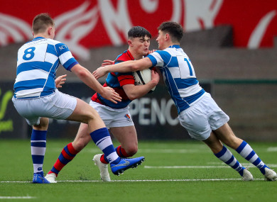 Rockwell's Stephen Grogan and Sean Cotter tackle Donnchadh O'Callaghan of St Munchin's.