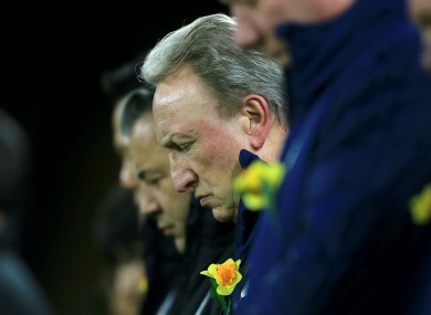 Neil Warnock bows his head in remembrance of Emiliano Sala.