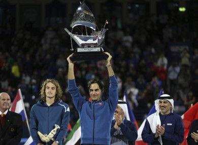 100 not out: Federer lifts the trophy.