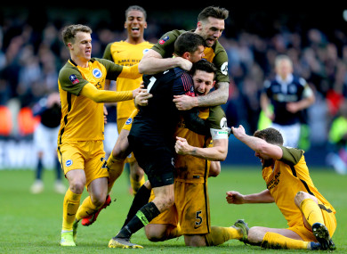 Brighton celebrate their dramatic shootout win.