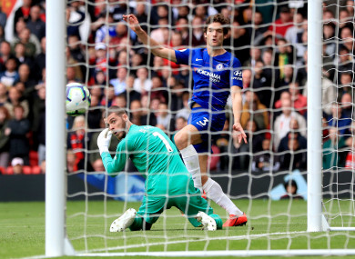 Marcos Alonso pounces on De Gea's error.