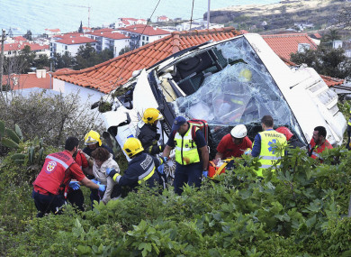 Emergency services attend the scene after a tour bus crashed at Canico, on Portugal's Madeira island.