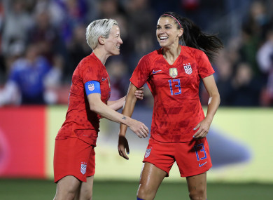 United states forward Alex Morgan (13) celebrates scoring her 100th goal with Megan Rapinoe.