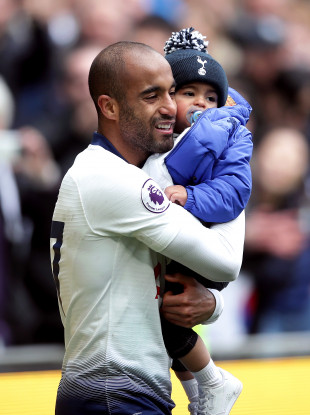 Tottenham's Lucas Moura celebrates with his son after the win against Huddersfield Town.