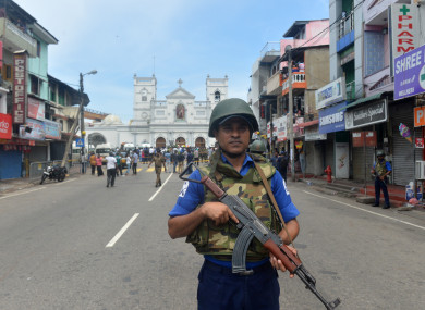 A soldier stands guard in front of the St. Anthony's Church in Colombo.