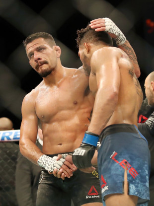 Rafael dos Anjos consoles Kevin Lee after their UFC bout in Rochester, New York.