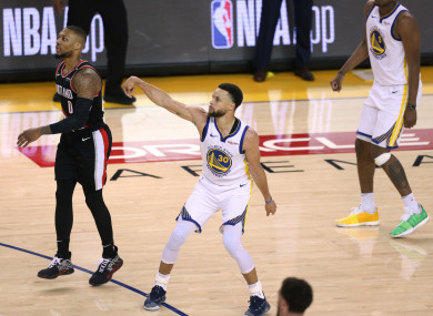 Curry celebrates as a eke three-pointer drops.