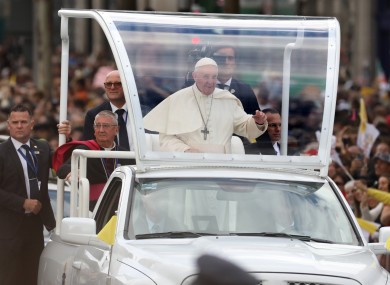 Crowds line the streets in Dublin city centre as Pope Francis passes by on his tour of the city, during the first day of his visit to Ireland.