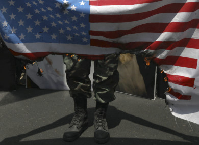 A demonstrator burns a US flag in Tehran.