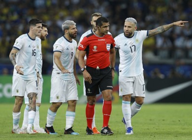 Referee Roddy Zambrano is surrounded by Argentina players during their Copa America defeat to Brazil.