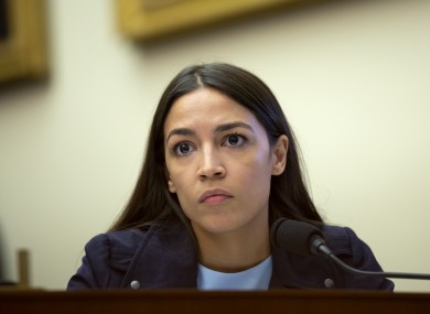 Alexandria Ocasio-Cortez listens as Federal Reserve Chairman Jerome Powell testifies.