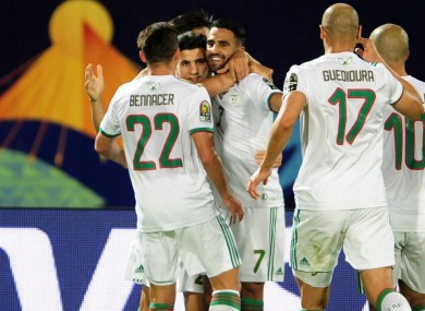 Riyad Mahrez (C) leads Algeria celebrations against Guinea.