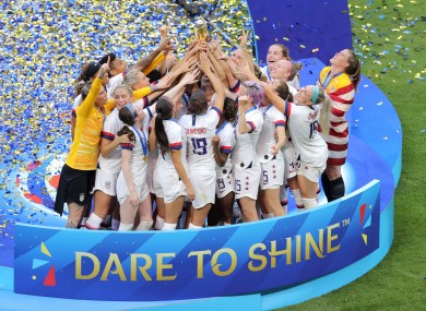 US players celebrate with the trophy.