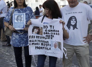 Reanta Grattani, a friend of the Orlandi family, holds a sign with photos of Emanuela Orlandi and Pope Francis and a message stating: 'I'm watching you from the sky, but you (referring to Pope Francis) please let them return my mortal remains to my mother.'