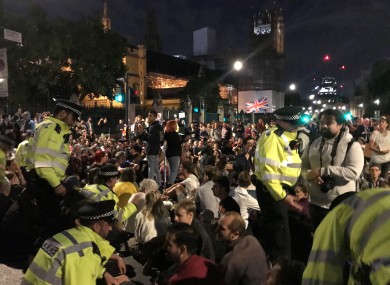 Police talking to protesters outside the Houses of Parliament in London this evening.