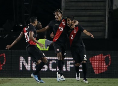 Heads up: Abram, right, leads Peru's celebrations.