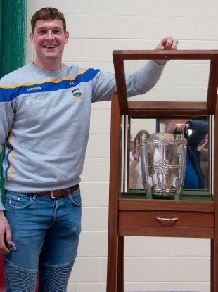 Séamus Callanan standing alongside the display cabinet he made for his Leaving Cert project.
