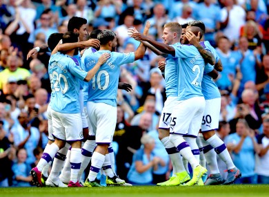 Manchester City players celebrate as David Silva scores their first goal.