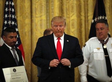 Donald Trump stands with Medal of Valor recipients during a ceremony at the White House, 9 September.