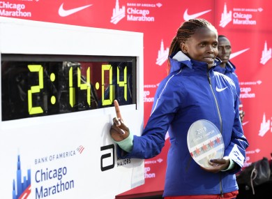 Brigid Kosgei of Kenya, poses with her time after winning in Chicago.