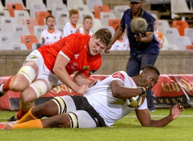 Junior Pokomela of Toyota Cheetahs scores a try despite the efforts of Jack O'Donoghue of Munster.