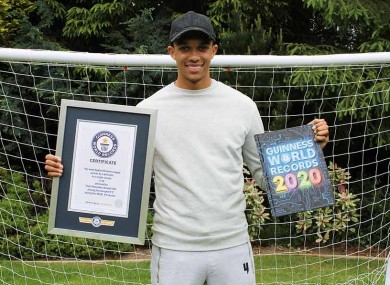 Holding his certificate and a copy of the 2020 edition of the book.