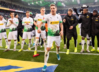 Patrick Herrmann and team-mates celebrate victory in front of supporters.